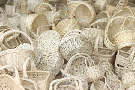 Wicker baskets stacked together, close-up. White wicker baskets for Easter, fruits or vegetables. Selling baskets