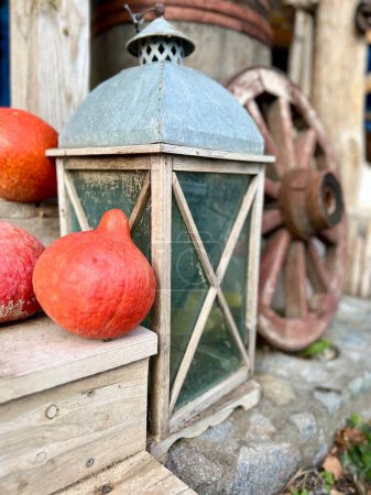 Pumpkins and lantern near house. Selective focus on the part of the feeder. High quality photo