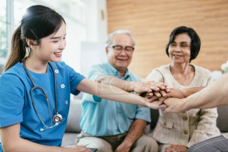 Photo for Happy Asian elderly people hands join together in the middle with young woman nursing elderly care. - Royalty Free Image