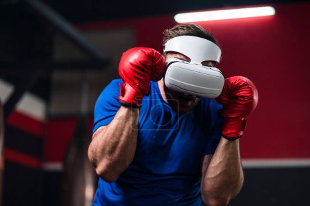 Photo for Medium close up and motion blur of sport man wearing VR headset to exercise with simulation boxing games, Young man athlete boxer virtual reality combat experience activity. New Experience lifestyle. - Royalty Free Image