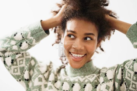 Téléchargez les photos : Gros plan Portrait de charmante femme afro-américaine avec confiance pour sourire avec de belles dents. Style de vie dame optimiste avec coiffure bouclée. - en image libre de droit