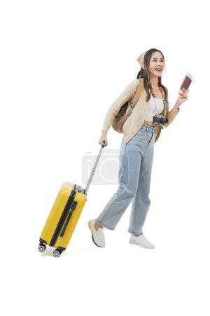 Photo for Cute asian young woman traveler pulling suitcase, luggage holding passport looking happy and exciting for the next vacation, holiday season, roam alone, woman traveling, happy journey. - Royalty Free Image