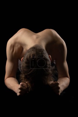 Photo for A 17 year old shirtless muscular teenage boy doing the plank - Royalty Free Image