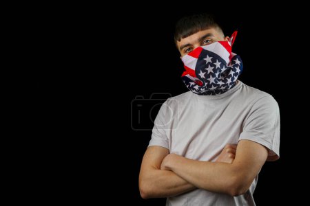 Photo for Teenage boy wearing an American flag mask against a black background - Royalty Free Image