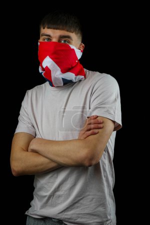 Foto de Adolescente con una máscara de bandera británica sobre un fondo negro - Imagen libre de derechos