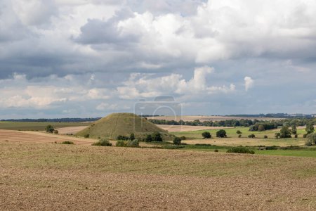 Photo for Silbury hill surrounded by fields in Wiltshire, United Kingdom - Royalty Free Image