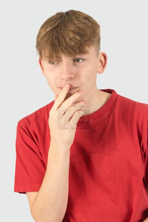 Photo for A studio portrait of a nervous fifteen year old teenage boy - Royalty Free Image
