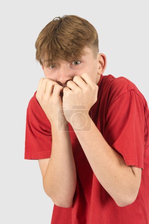 Photo for A studio portrait of a nervous fifteen year old teenage boy - Royalty Free Image