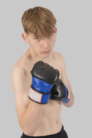 Photo for Shirtless male teenage MMA fighter with his guard up - Royalty Free Image