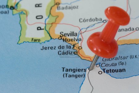 A red pin stuck into a map of Western Europe, pinpointing the location of Tangiers