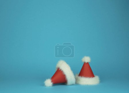 Photo for Two Santa Clauss red with white feather hats on green background. Minimal styled card. High quality photo - Royalty Free Image