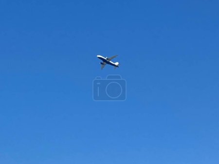 An Airplane is Approaching High Altitude . It Took off from Chania Creta Airport and Passing over the Chania City of Greece. The Footage was Captured on 03-August-2023. High quality photo