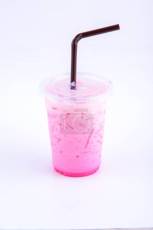 Ice pink milk. Beverage for summer with brick wall background.