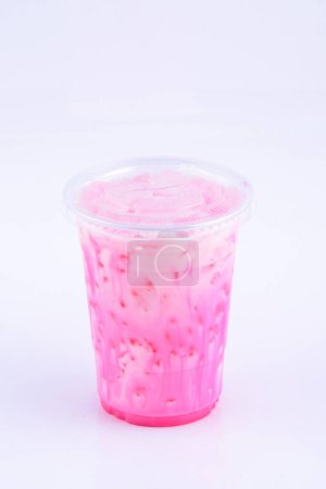 Ice pink milk. Beverage for summer with brick wall background.