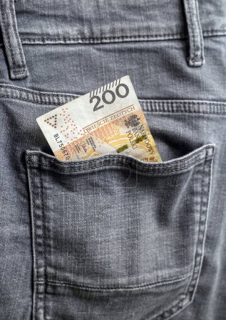 Photo for A Polish banknote sticking out of the pocket of gray trousers - Royalty Free Image