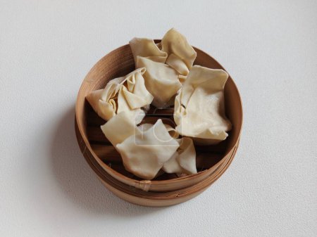 Photo for Raw dumpling or dimsum on bamboo steamer. It is traditional food from china. Savory taste. - Royalty Free Image