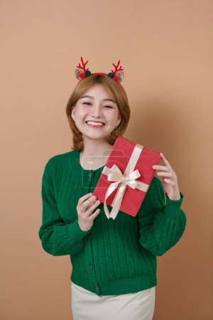 Photo for Adorable photo of attractive woman with beautiful smile holding a red gift box Christmas and New Year concept - Royalty Free Image