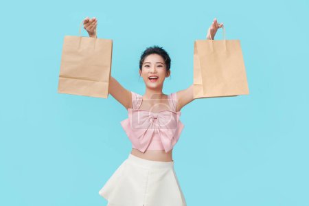 Photo for Happy shopping young woman show bags - isolated on blue background, - Royalty Free Image
