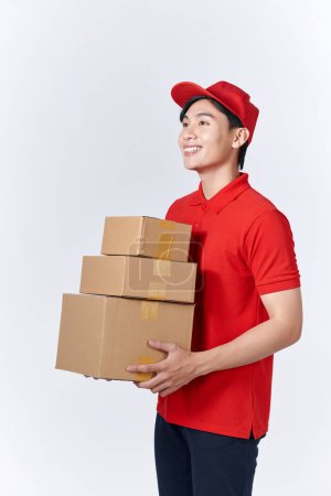 Photo for Delivery man in red uniform isolated on white background, studio portrait. - Royalty Free Image