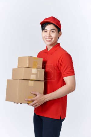 Foto de Asian man carries the boxes, isolated, white background - Imagen libre de derechos