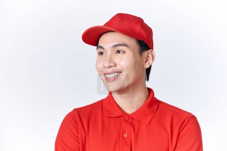Photo for Young handsome man wearing delivery courier uniform looking away to side with smile on face - Royalty Free Image