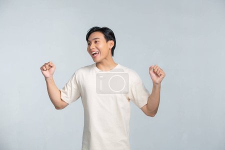 Photo for A portrait of happy excited young Asian man isolated on white background - Royalty Free Image