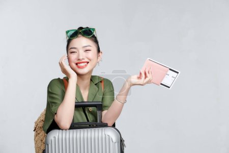 Photo for Cheerful woman with passport and  suitcase - Royalty Free Image