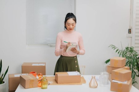 Photo for Portrait Asian small business owner warehouse home office, online market packing delivery. - Royalty Free Image