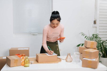 Photo for Closeup view of female online store packing package post shipping boxes preparing delivery - Royalty Free Image