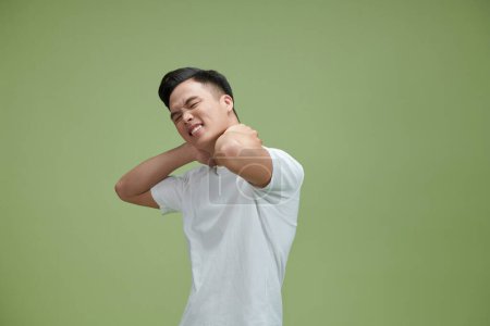 Photo for Young man suffering from neck pain, horizontal - Royalty Free Image