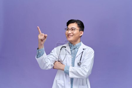 Photo for Smart young doctor pointing at something - Royalty Free Image