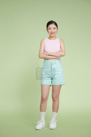 Photo for Full length photo of pretty girl crossed hands isolated on pastel green background - Royalty Free Image