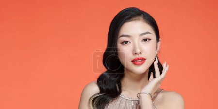 Photo for Asian beautiful woman with red lipstick isolated on red background. - Royalty Free Image