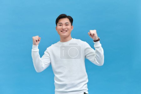 Photo for Handsome excited man  hold  fists raised up gesture - Royalty Free Image