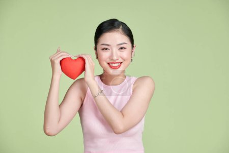 Photo for Young smile woman hold red heart. - Royalty Free Image