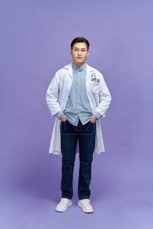 Photo for Portrait of male confident doctor over purple background studio, healthcare and Medical technology concept. - Royalty Free Image