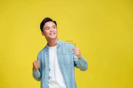 Photo for Young handsome man wearing casual clothes , celebrating victory and success very excited with raised arms - Royalty Free Image