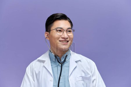 Photo for Portrait of confident positive smiling asian male doctor wearing medical white uniform coat and stethoscope - Royalty Free Image