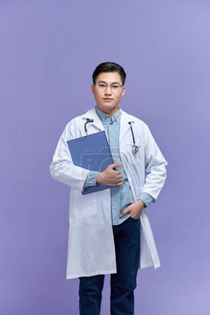 Photo for Asian male doctor portrait on purple background - Royalty Free Image