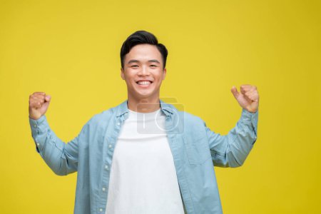 Photo for Successful young asian man with arms up - Royalty Free Image