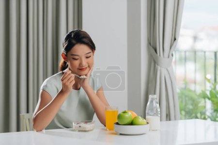 Photo for Woman eating muesli with milk for breakfast in the morning - Royalty Free Image