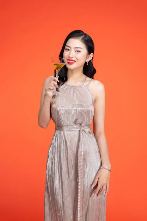 Photo for Woman, portrait smile and glass champagne standing in stylish fashion isolated on red background - Royalty Free Image