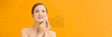 Photo for Beauty woman cleaning her face with cotton swab pad isolated on banner background - Royalty Free Image