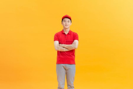 Photo for Portrait of asian delivery man on yellow background - Royalty Free Image