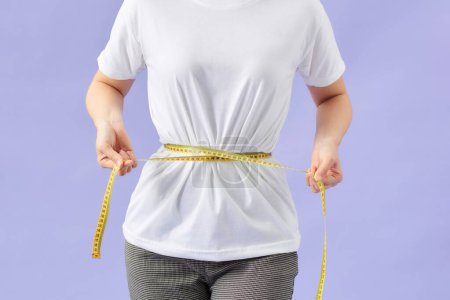 Photo for Young sport woman with tape measure - Royalty Free Image