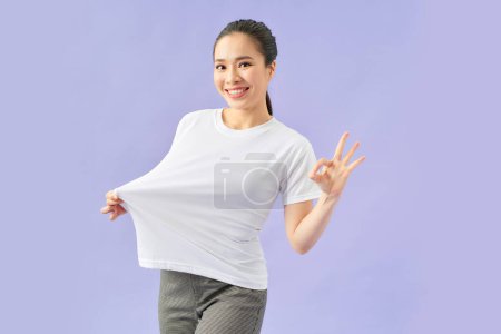 Photo for Slim attractive girl wearing white big t shirt, female lost weight and being proud of it, - Royalty Free Image