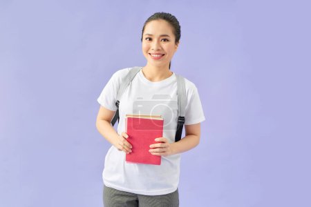 Photo for Studio shot of cheerful attractive university student girl with books and backpack - Royalty Free Image