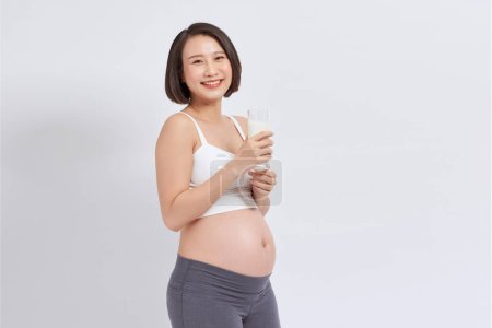 Photo for Care of Asian pregnant woman with milk. - Royalty Free Image
