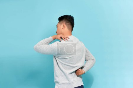 Photo for Isolated shot of a man in the back with neck and lower back pain - Royalty Free Image