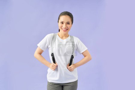 Photo for Beautiful young woman with stylish backpack on violet background - Royalty Free Image